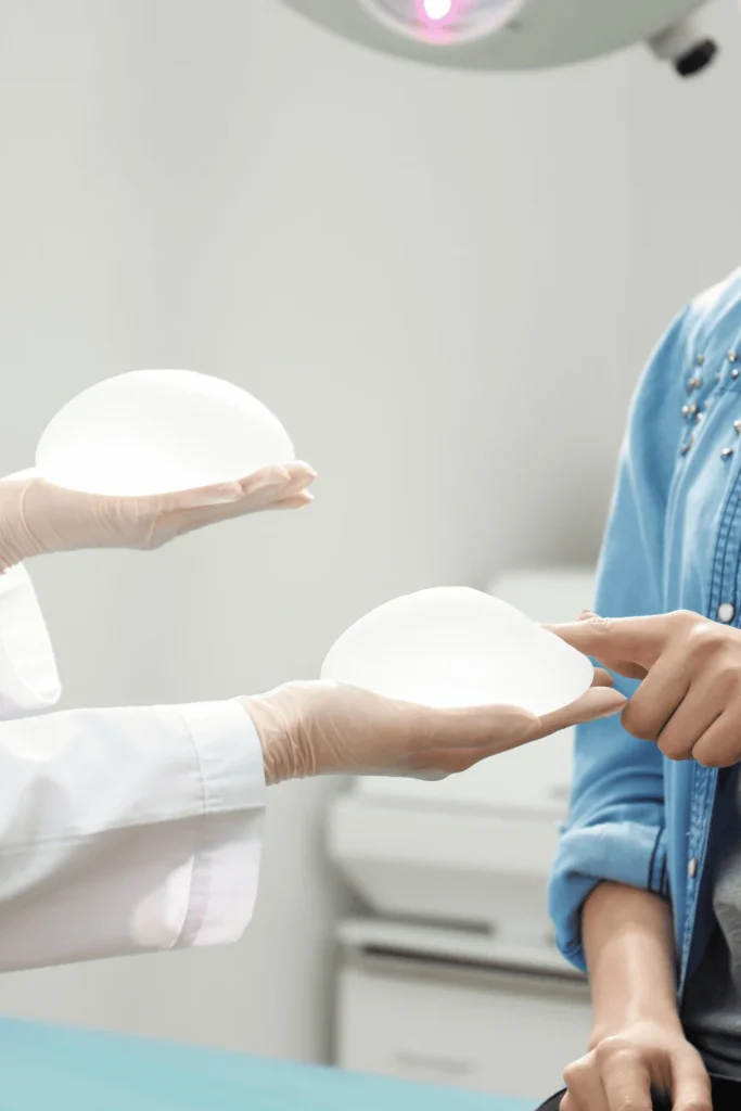 transgender breast augmentation woman pointing at breast implants